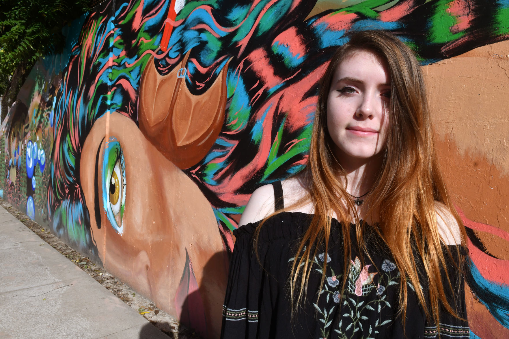 Madelynn Vogt artist of mermaid face on mural at Lincoln Road and 18th Street in Bettendorf.